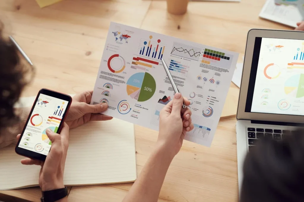 Two people conducting market research, with statistics being displayed on them. This is important when branding for cultural differences.