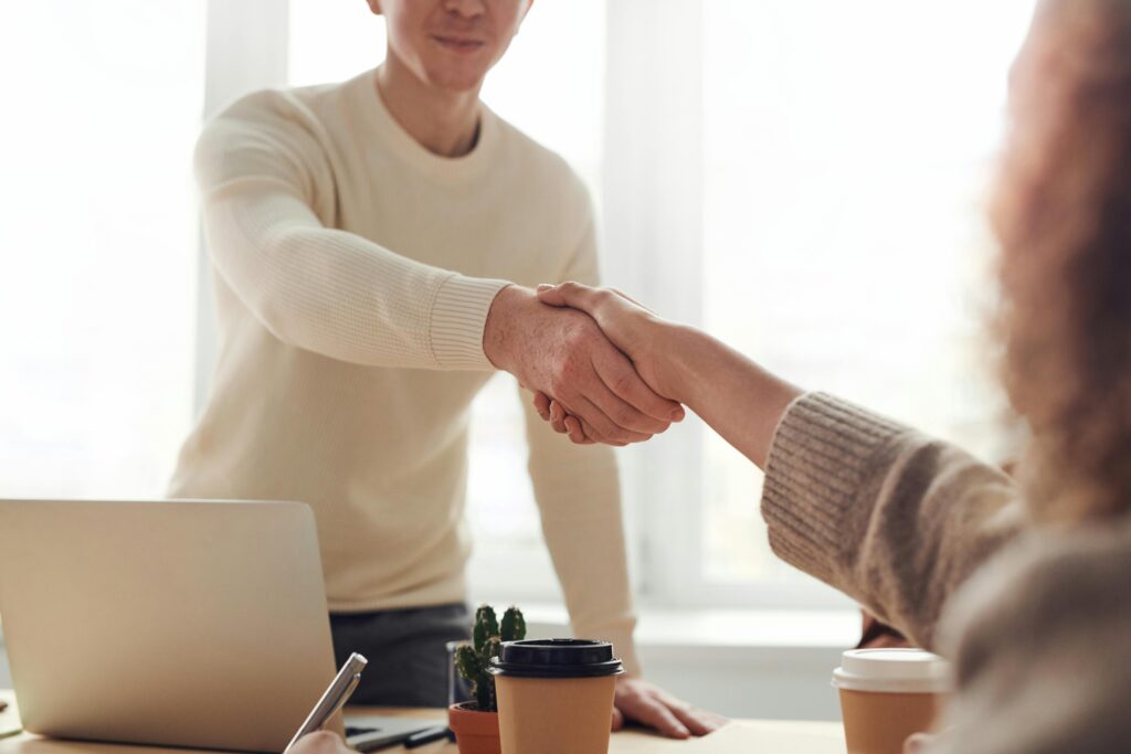 A handshake between two parties, representing a good client-agency relationship.